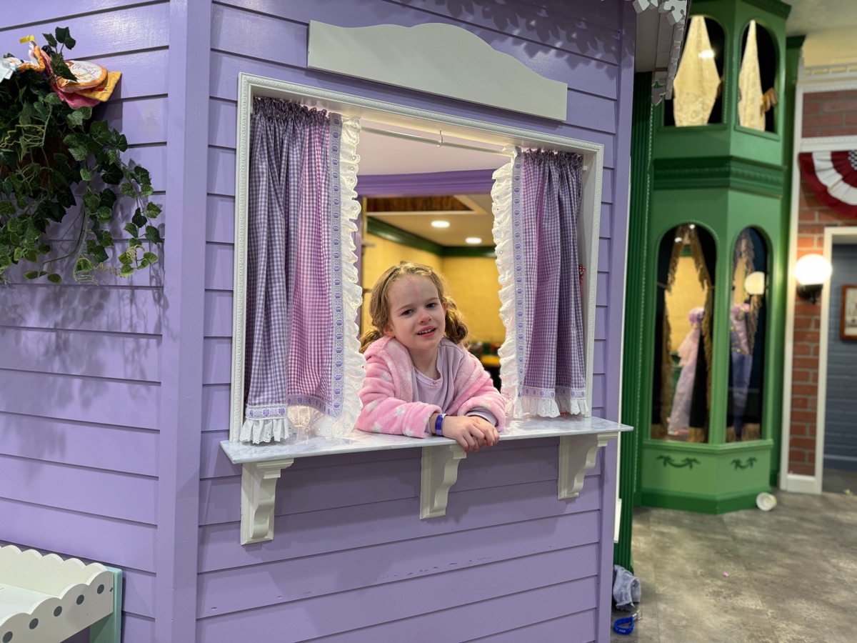 Esme smiling at the Sweet Shoppe serving window