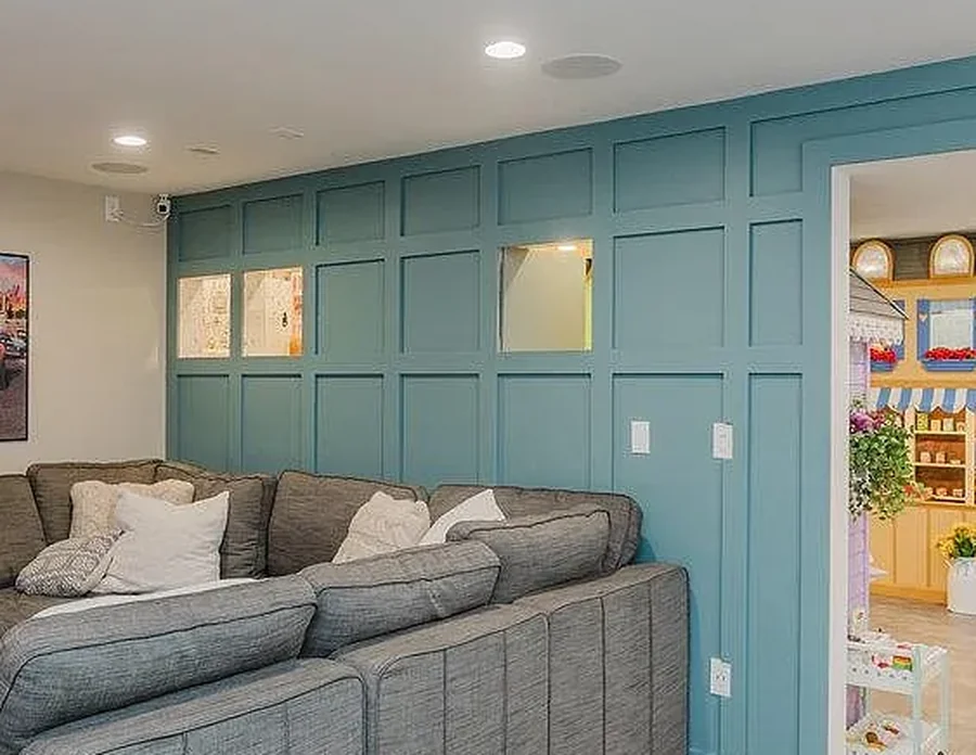 A teal board-and-batten feature wall