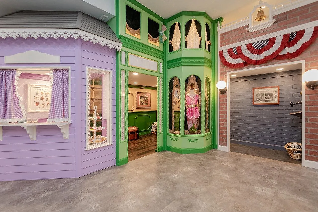 Indoor playhouse village: Sweet Shoppe, dress-up wardrobe, and fire station