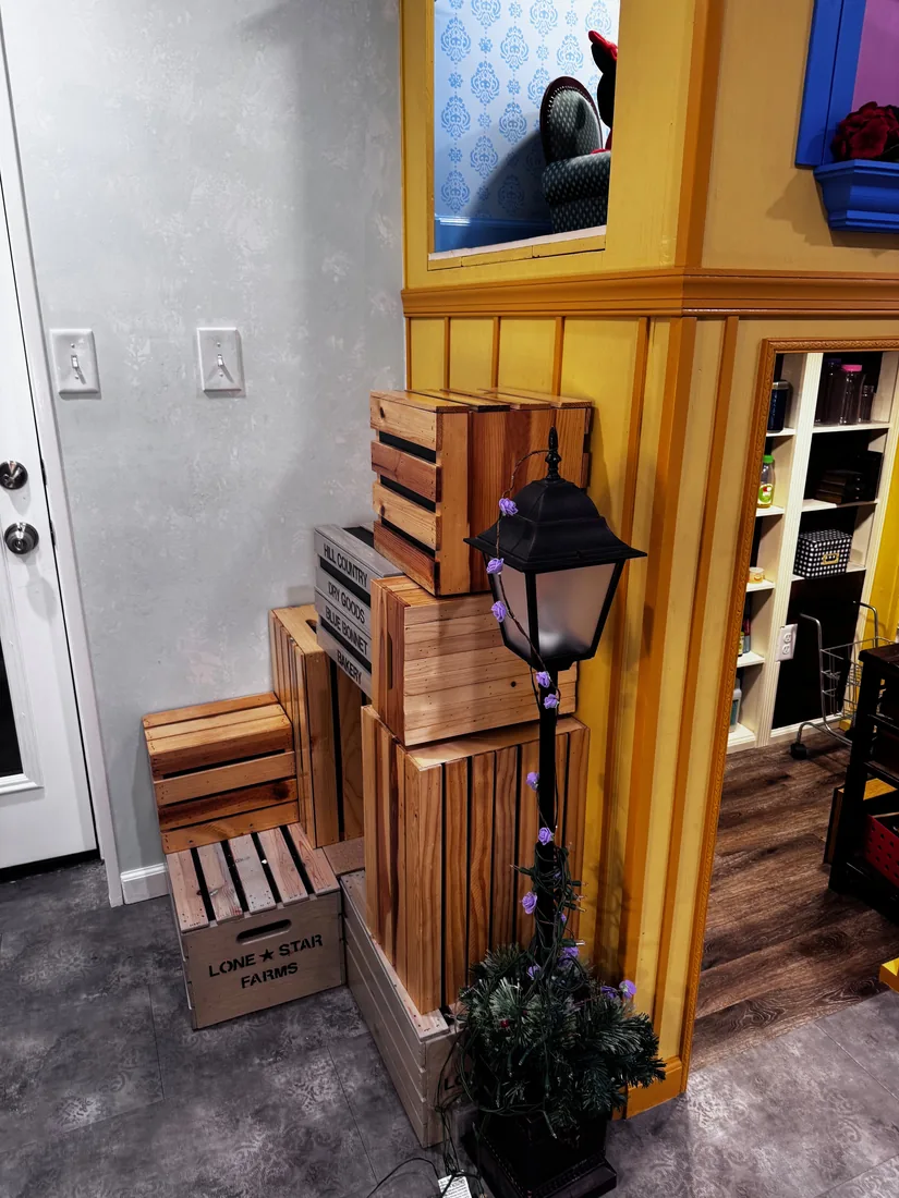 Stacked wooden-crate box stairs climbing the side of the Peterson Grocer toward the apartment above