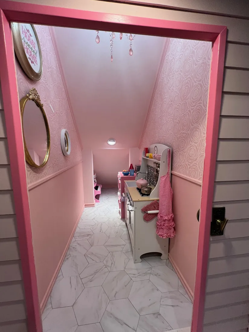 Looking through Rose Cottage's pink doorway into a rosy interior