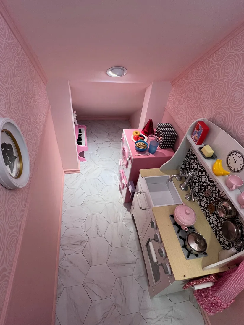 Inside Rose Cottage — room for a play kitchen on the marble-look floor
