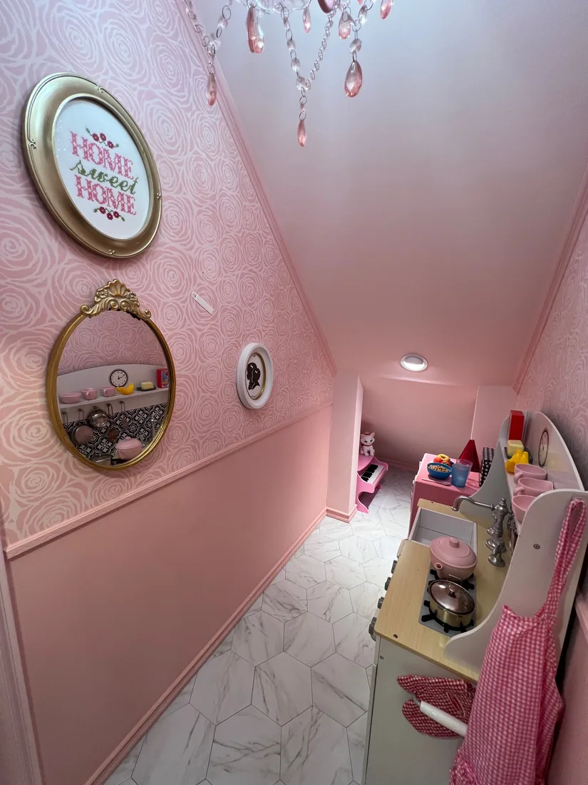 Inside Rose Cottage — rose wallpaper, a gilt oval mirror, and a framed 'Home Sweet Home' print