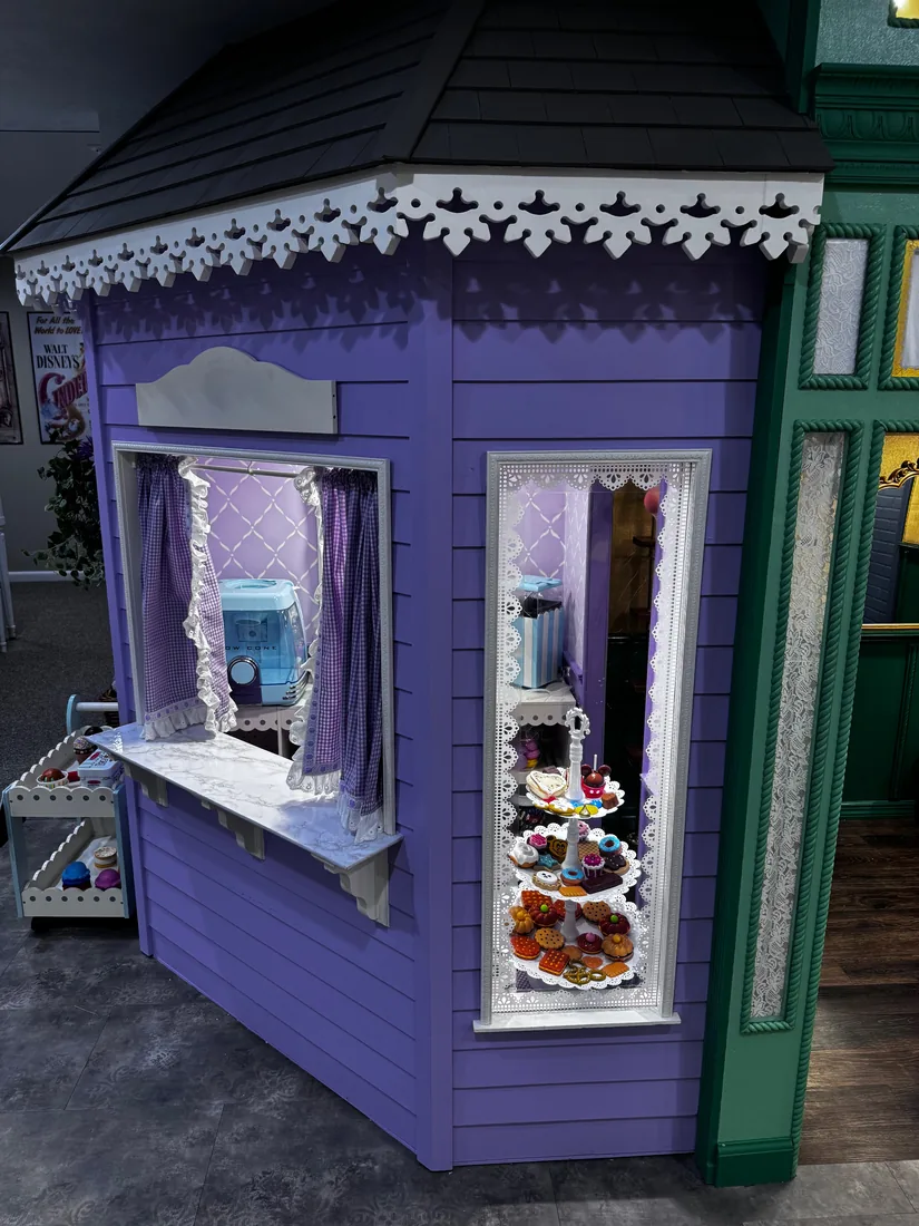 The Sweet Shoppe's side display window — a lace-curtained bay ready to show off the day's treats