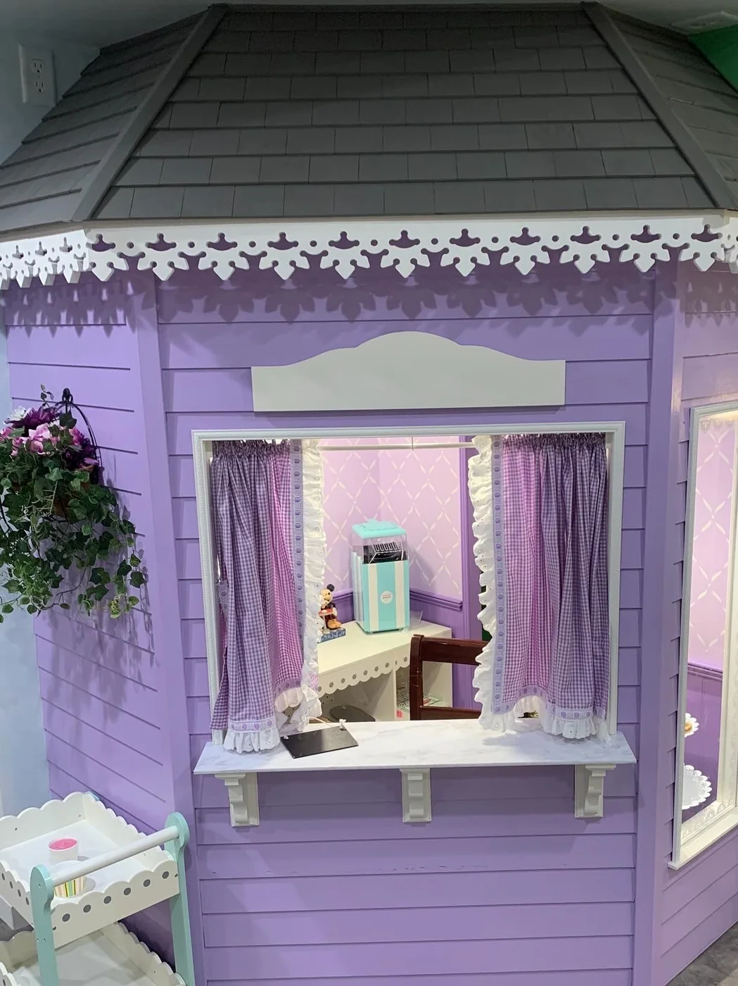 Miss Gracie's Sweet Shoppe playhouse — a lavender bay-window candy shop with gingerbread trim and a serving counter